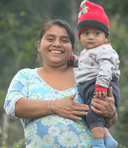 The garden is providing the family with more income and better foods. Jose's wife and child