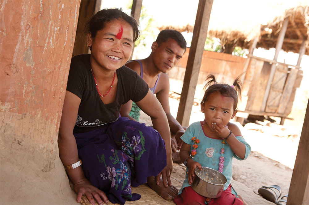 Amrita Saru sits with her husband, Kaman Singh Saru, and daughter Susmita, age 3, outside their home. Kaman works in India much of the year. They also have a 10-year-old son, Deependra. Amrita Saru sits with her husband, Kaman Singh Saru, and daughter Susmita, age 3, outside their home. Kaman works in India much of the year. They also have a 10-year-old son, Deependra.