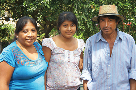 Maria Torres Tzab, Fatima Castillo Torres and Nicolas Castillo Ucam stand outside their home in Mani. Maria Torres Tzab, Fatima Castillo Torres and Nicolas Castillo Ucam stand outside their home in Mani.